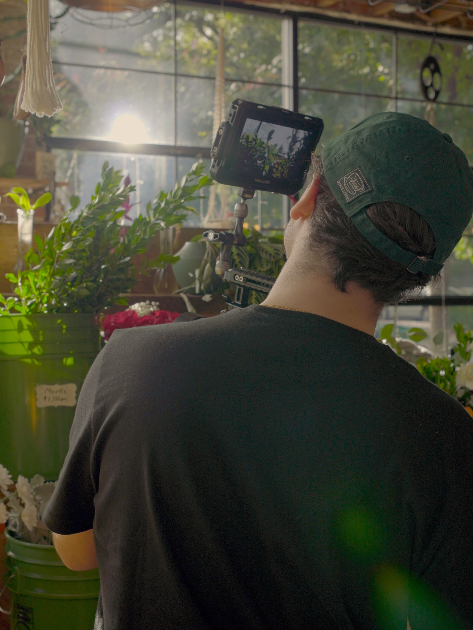 Camera operator filming inside a flower shop